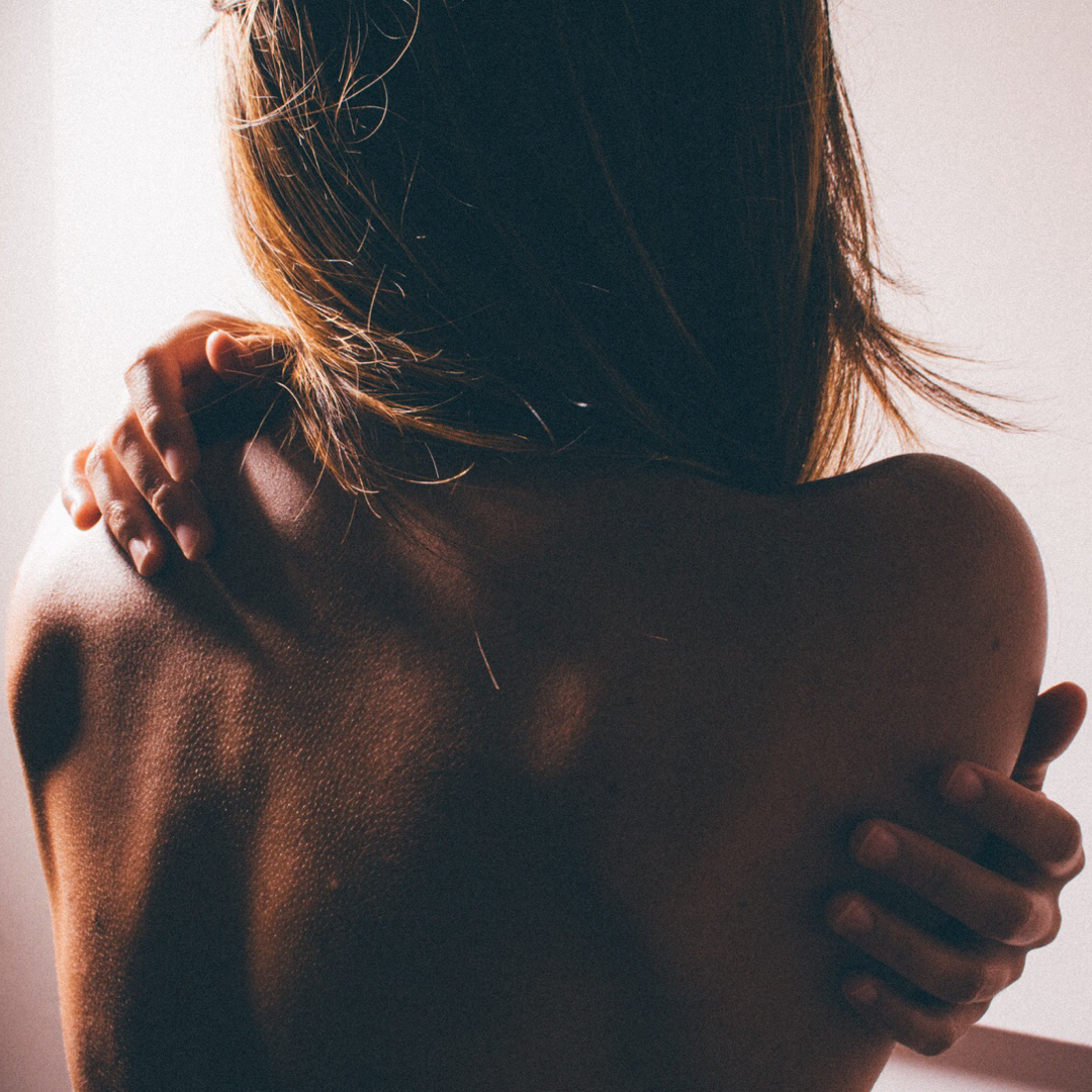 Girl holding onto her back, relief from back pain.
